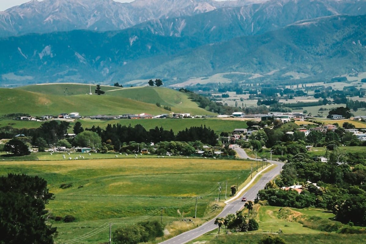 green grass field near mountain during daytime