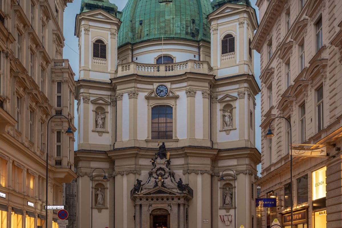 people walking in front of brown concrete building during daytime