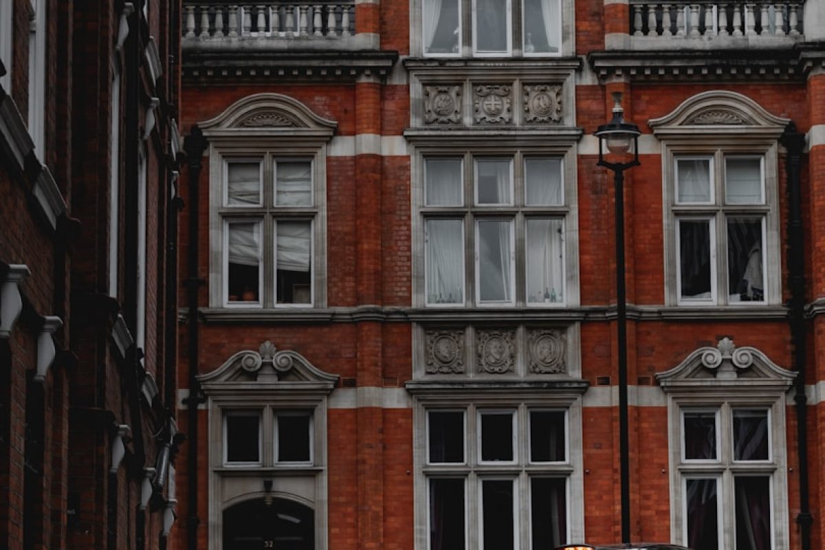 black car near brown concrete building during daytime