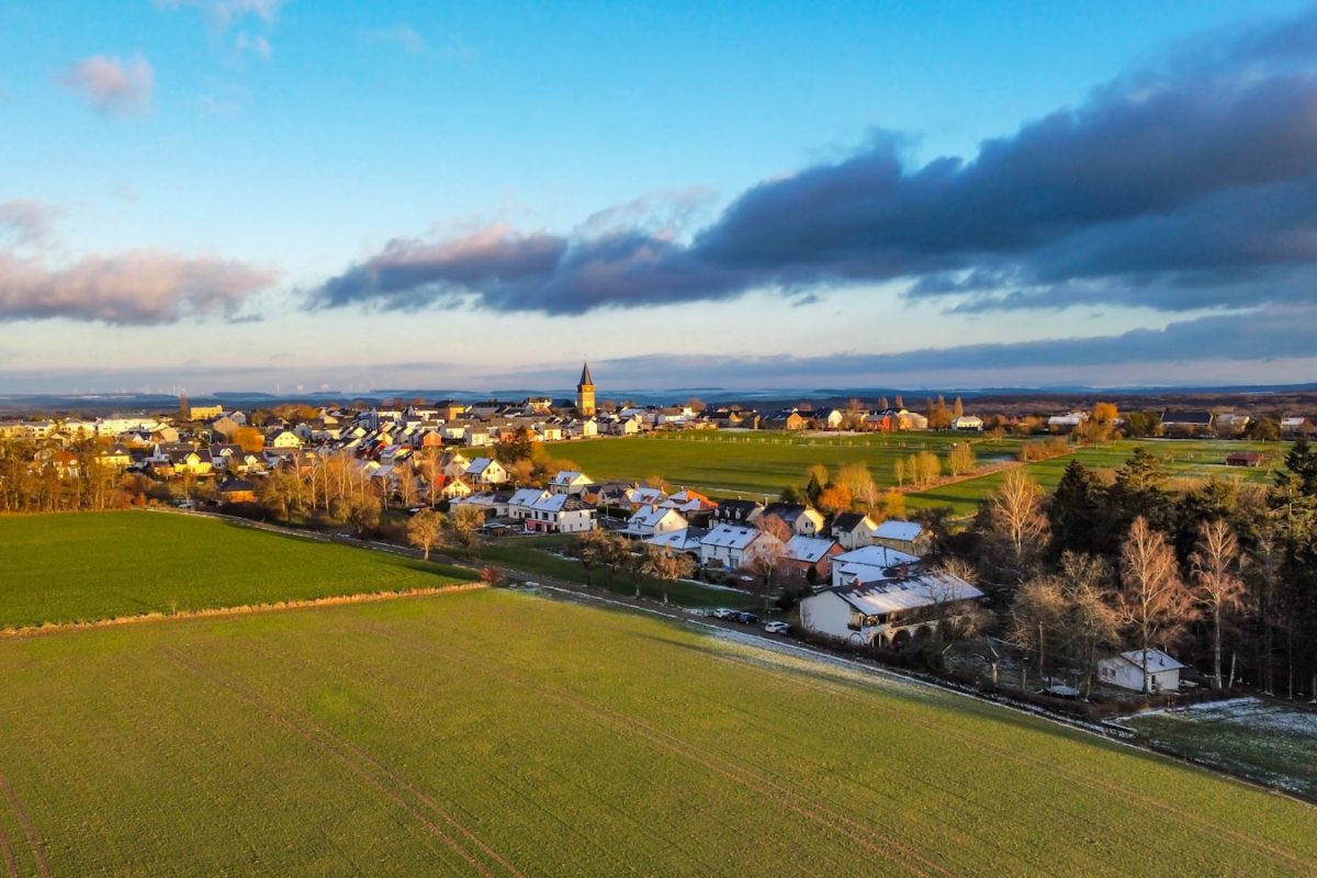 green grass field near body of water during daytime