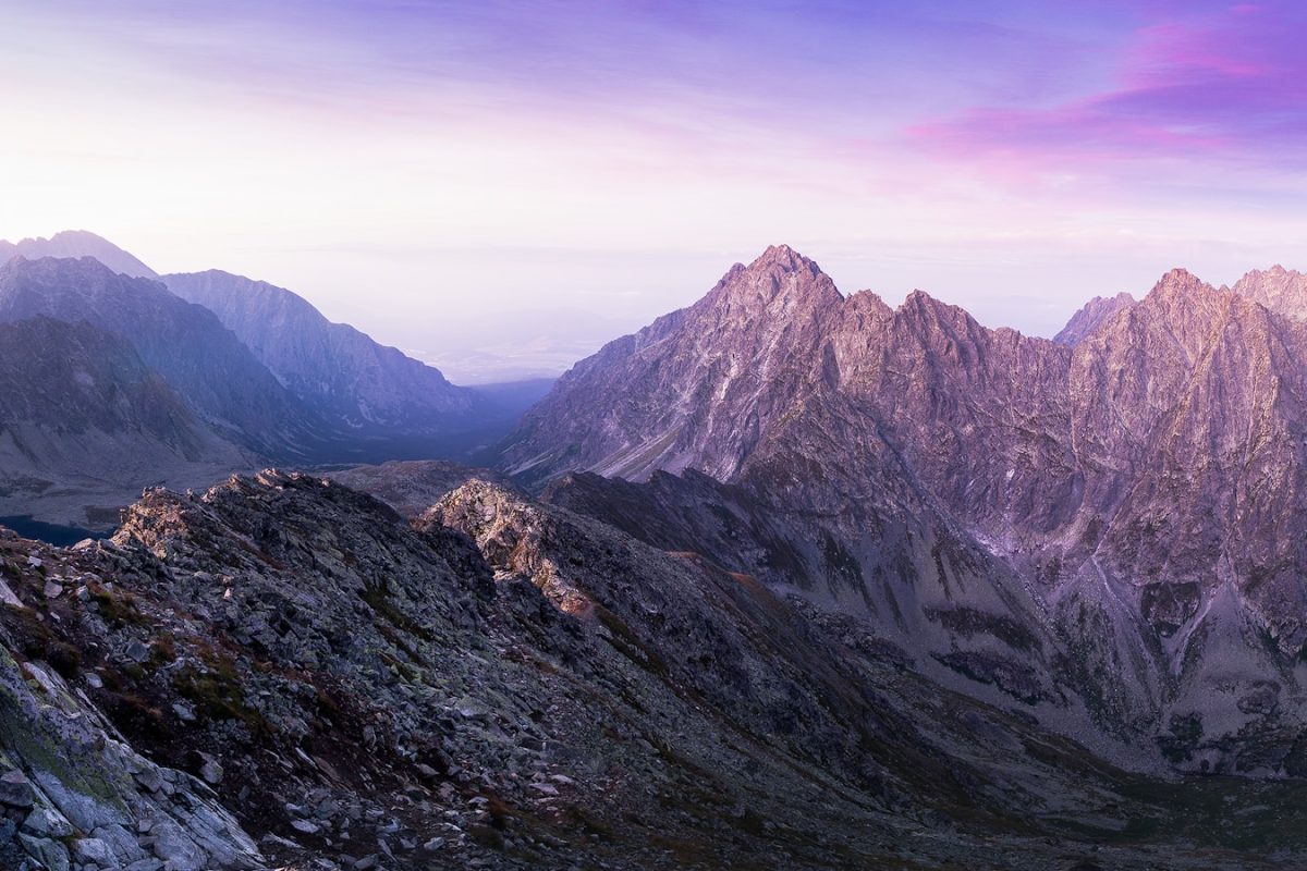 landscape photography of mountain ranges under purple and pink skies
