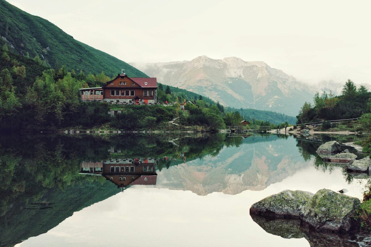 red house near body of water during daytime