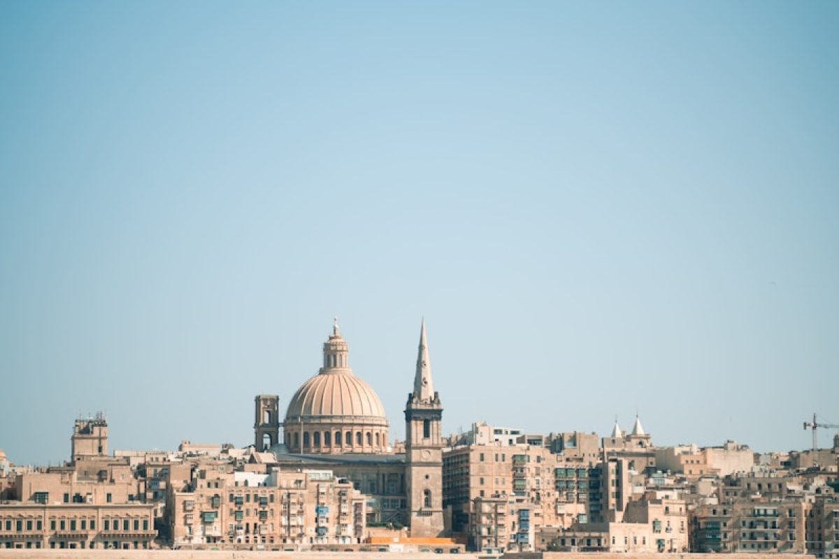 white concrete building near body of water during daytime