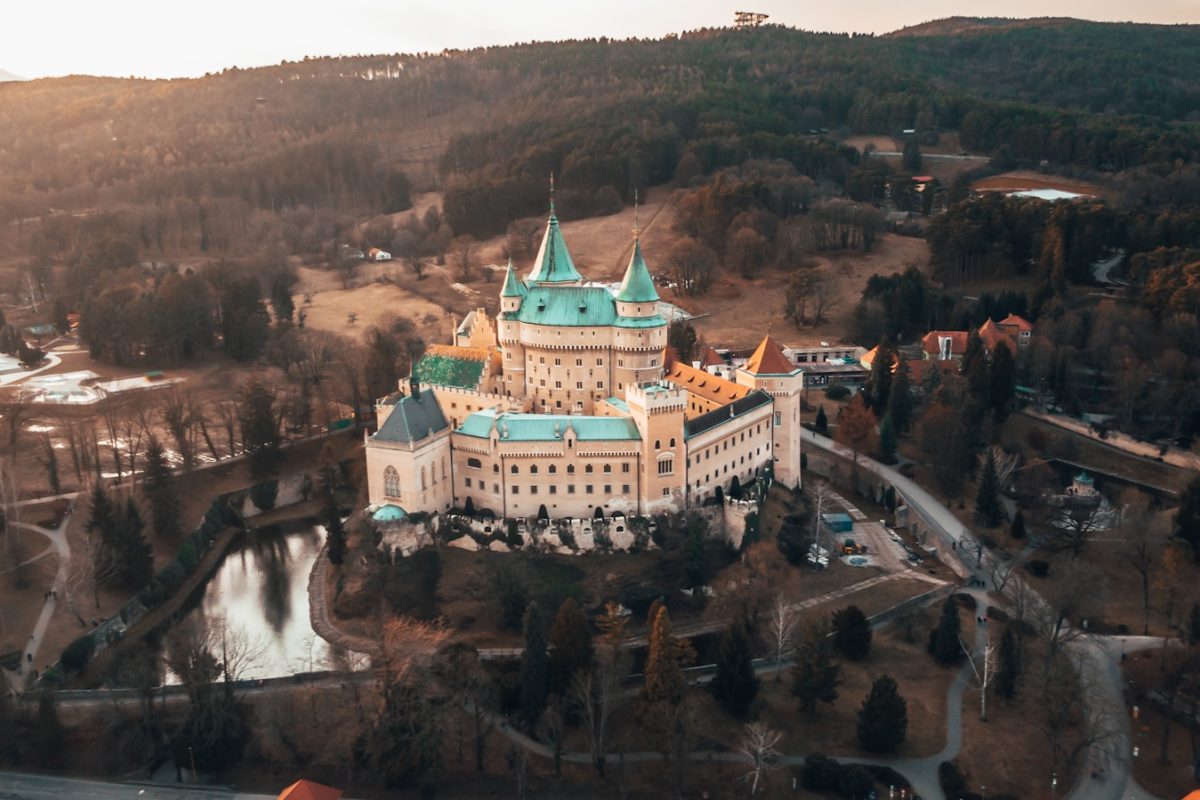 white and brown concrete building near river during daytime